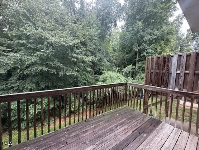 a balcony with wooden floor and fence