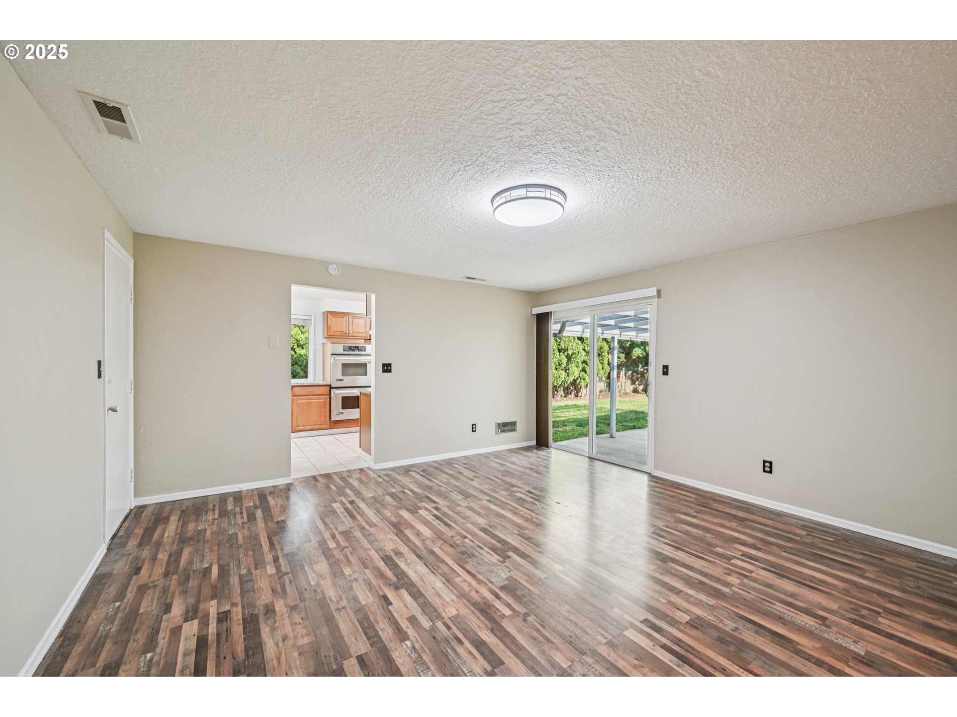 1631 North Clark Street Cornelius, OR 97113 - Photo 13 of 29 a view of an empty room with wooden floor and a window