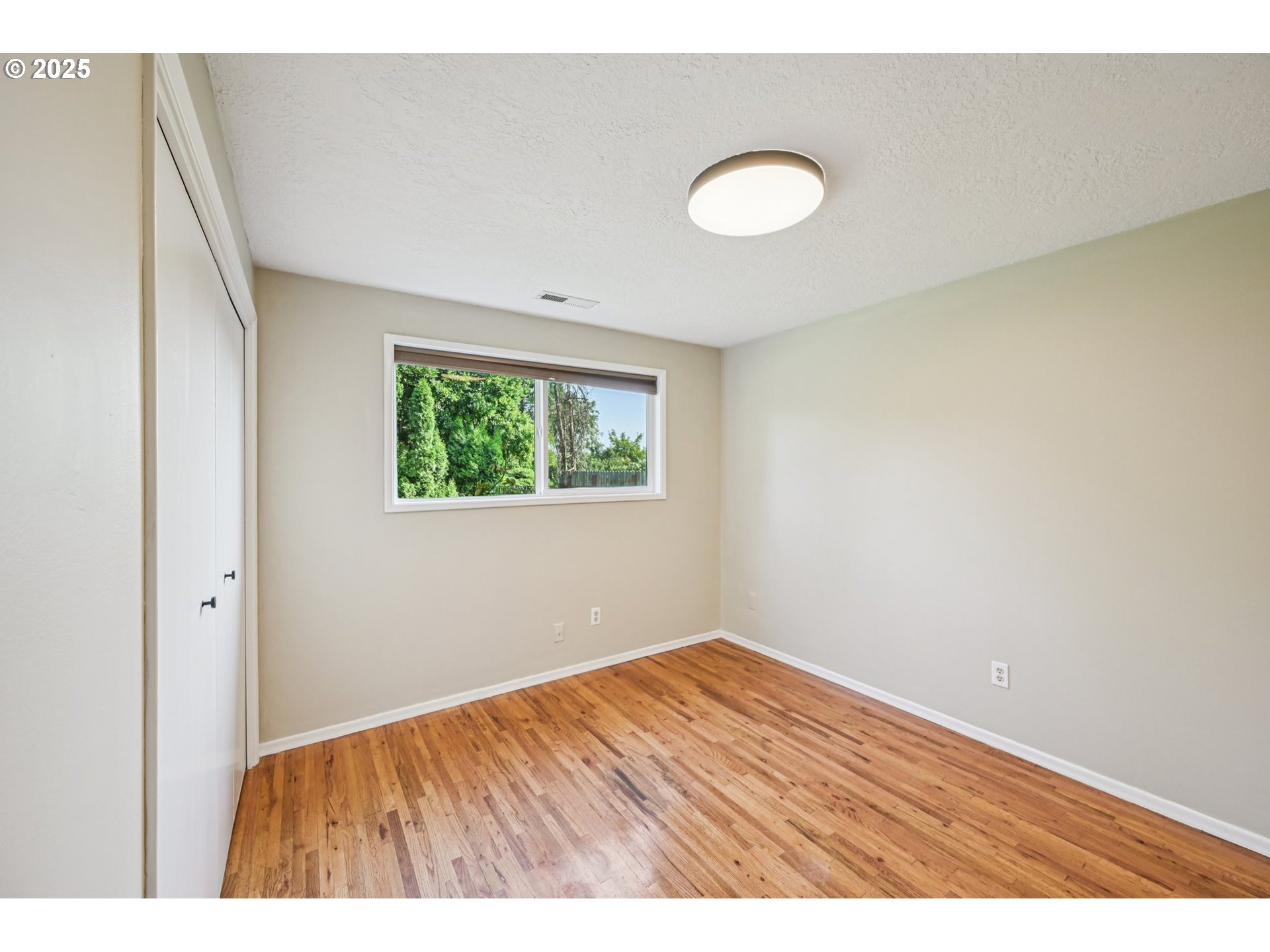 1631 North Clark Street Cornelius, OR 97113 - Photo 23 of 29 a view of an empty room with wooden floor and a window