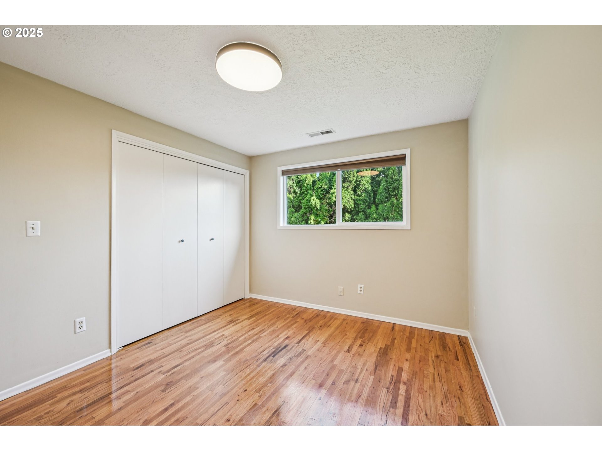 1631 North Clark Street Cornelius, OR 97113 - Photo 24 of 29 a view of an empty room with wooden floor and a window