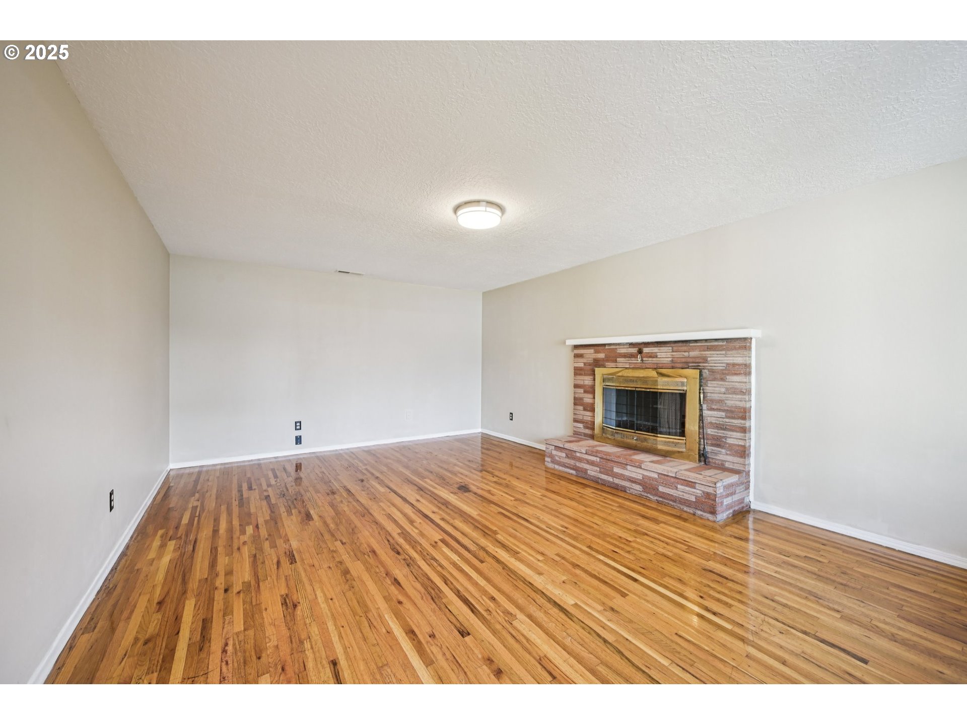 1631 North Clark Street Cornelius, OR 97113 - Photo 5 of 29 a view of empty room with wooden floor and fireplace