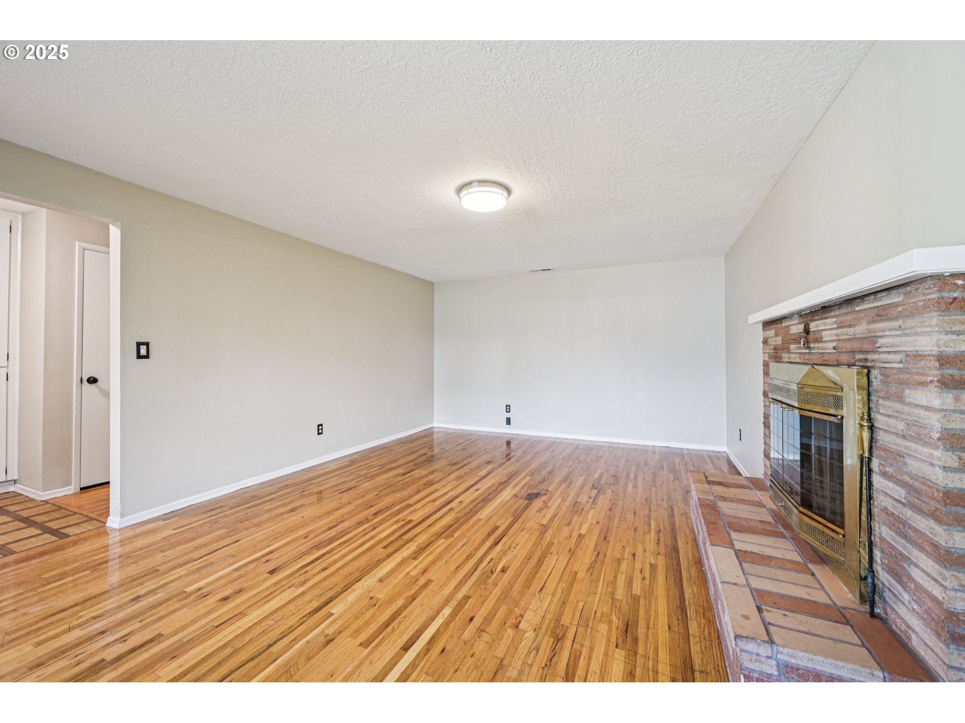 1631 North Clark Street Cornelius, OR 97113 - Photo 6 of 29 a view of empty room with wooden floor and fireplace