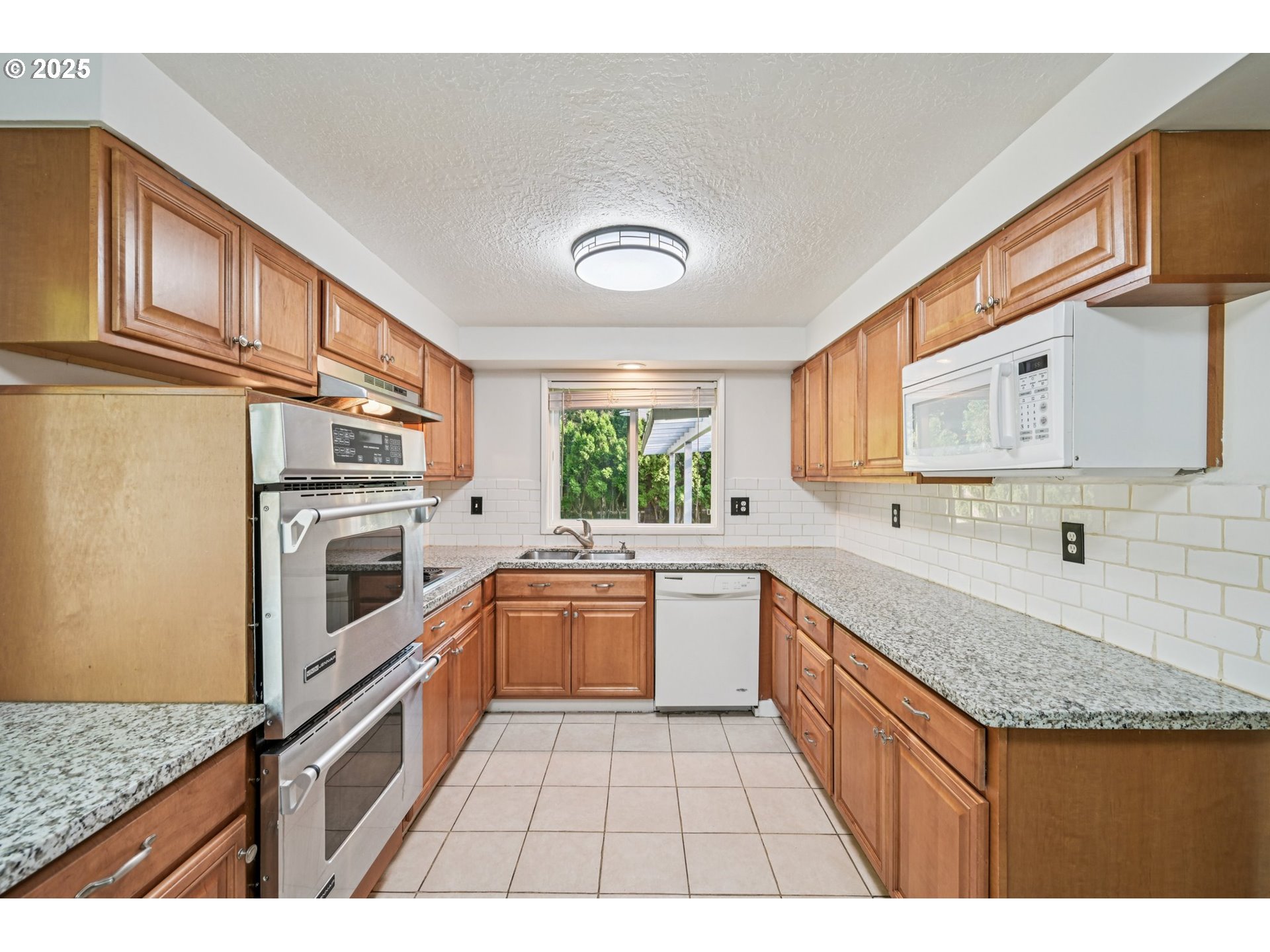1631 North Clark Street Cornelius, OR 97113 - Photo 10 of 29 a kitchen with granite countertop stainless steel appliances a sink and cabinets