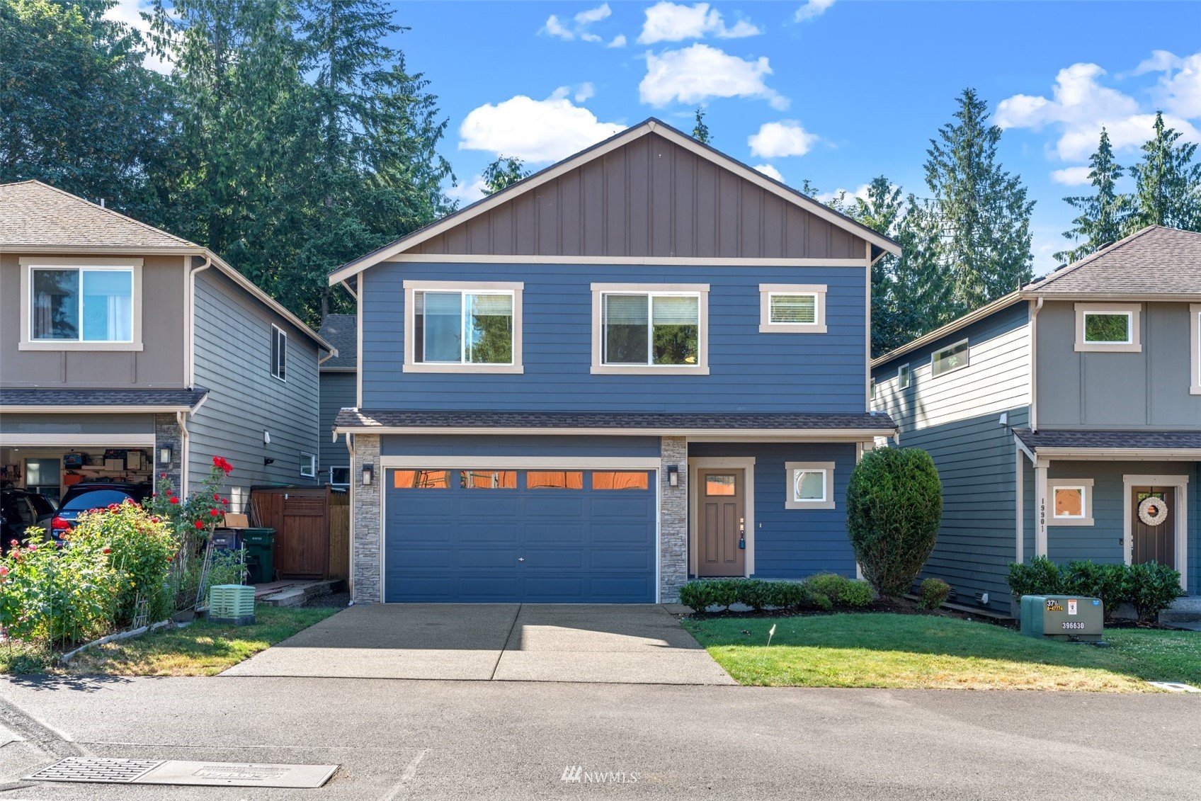 19833 3rd Avenue Southeast Bothell, WA 98012 - Photo 2 of 27 a front view of a house with a yard and garage