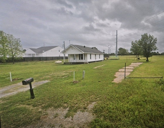an aerial view of a house with a yard
