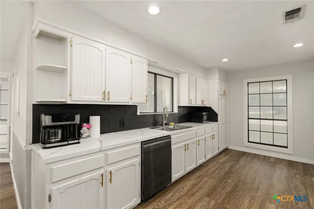 a kitchen with a stove and a white cabinet
