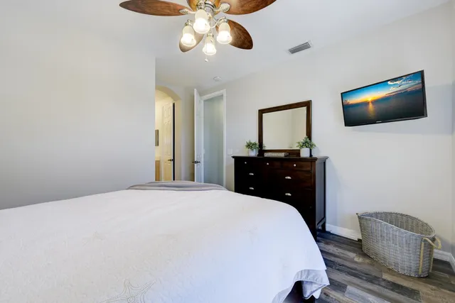 a bedroom with a bed and a flat screen tv