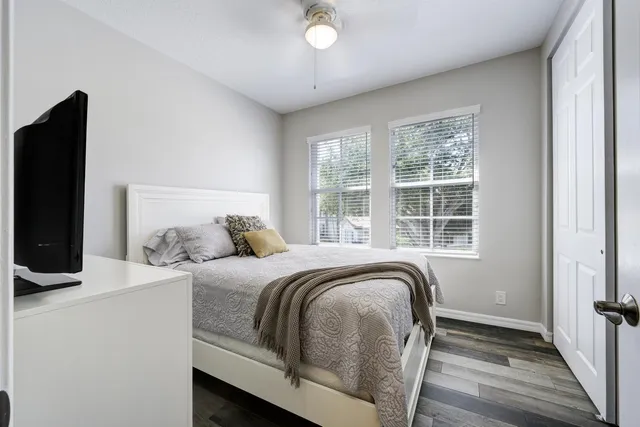 a bed sitting in a bedroom next to a window