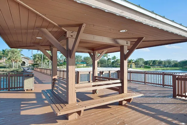 a view of a patio with wooden floor a yard tables and chairs