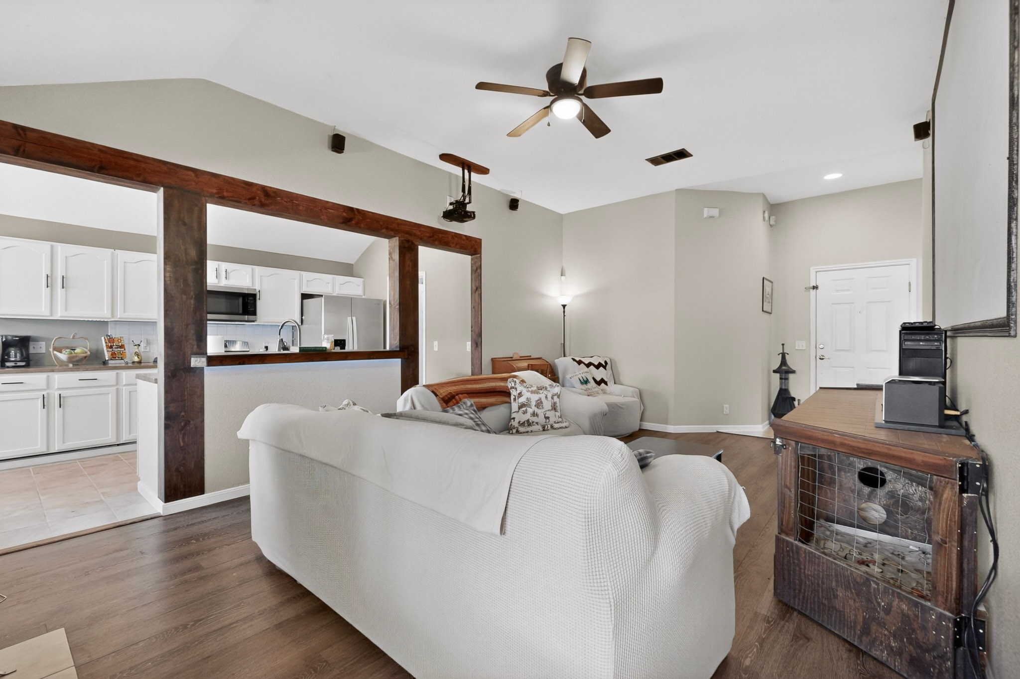 15104 Mimebark Way Austin, TX 78724 - Photo 8 of 38 Spacious living area featuring wood-finish flooring, vaulted ceilings, and a ceiling fan with integrated lighting