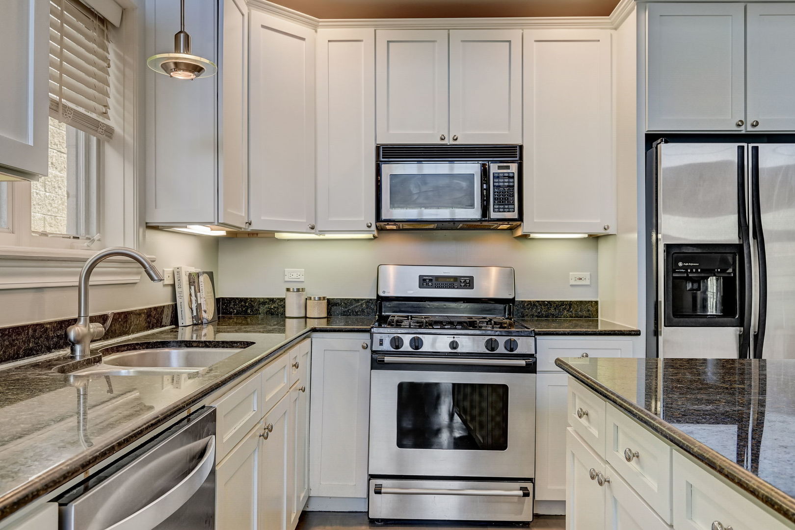 1367 North Mohawk Street, Unit 3N Chicago, IL 60610 - Photo 13 of 37 a kitchen with granite countertop white cabinets and stainless steel appliances