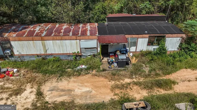 a view of a house with yard and sitting area
