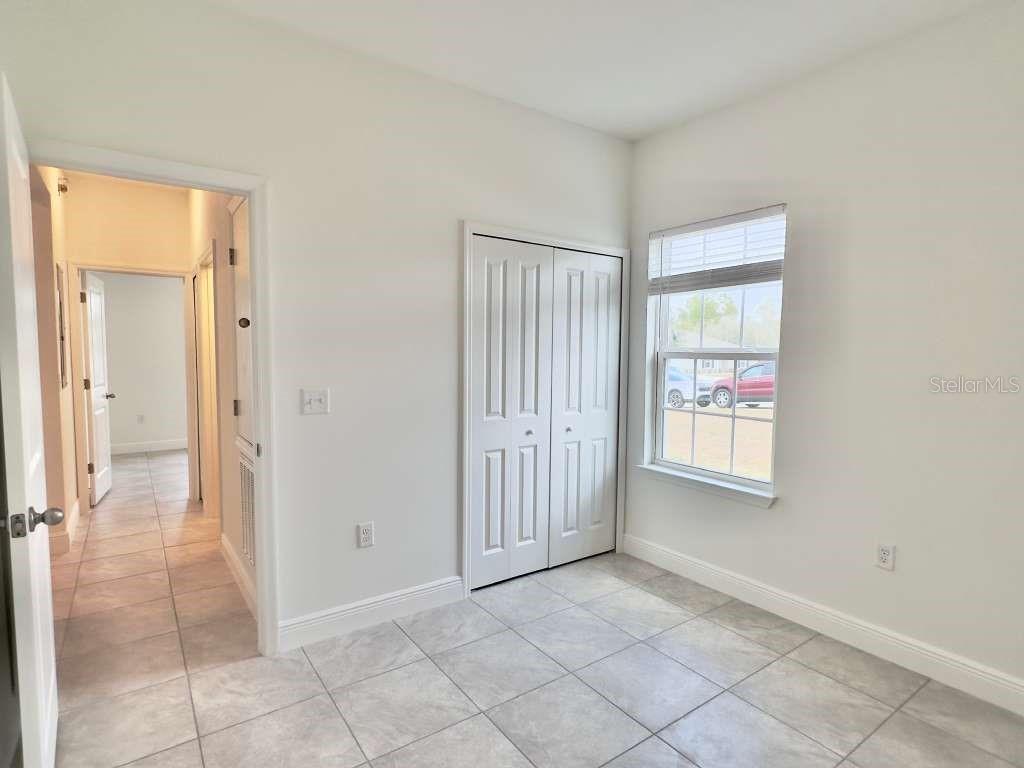 15885 Southwest 35th Court Road, Unit 1 Ocala, FL 34473 - Photo 16 of 27 an empty room with windows and closet