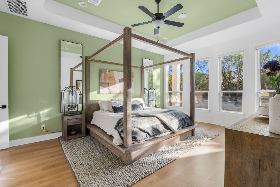 4612 Destination Way Jonestown, TX 78645 - Photo 18 of 37 a bed sitting in a bedroom next to a window