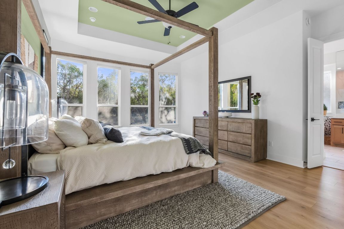 4612 Destination Way Jonestown, TX 78645 - Photo 19 of 37 a bedroom with a bed window and a dresser