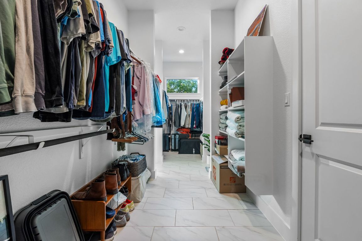 4612 Destination Way Jonestown, TX 78645 - Photo 22 of 37 a view of walk in closet with clothes and shoes