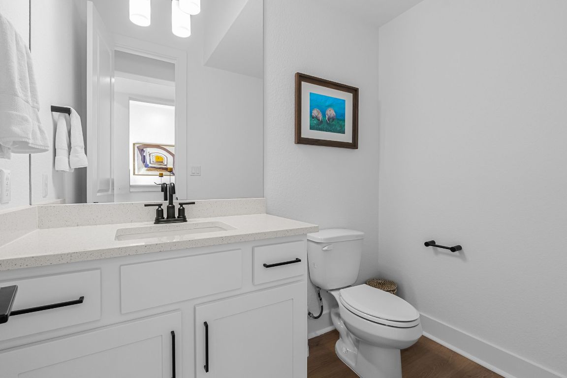 4612 Destination Way Jonestown, TX 78645 - Photo 24 of 37 a bathroom with a toilet sink and mirror