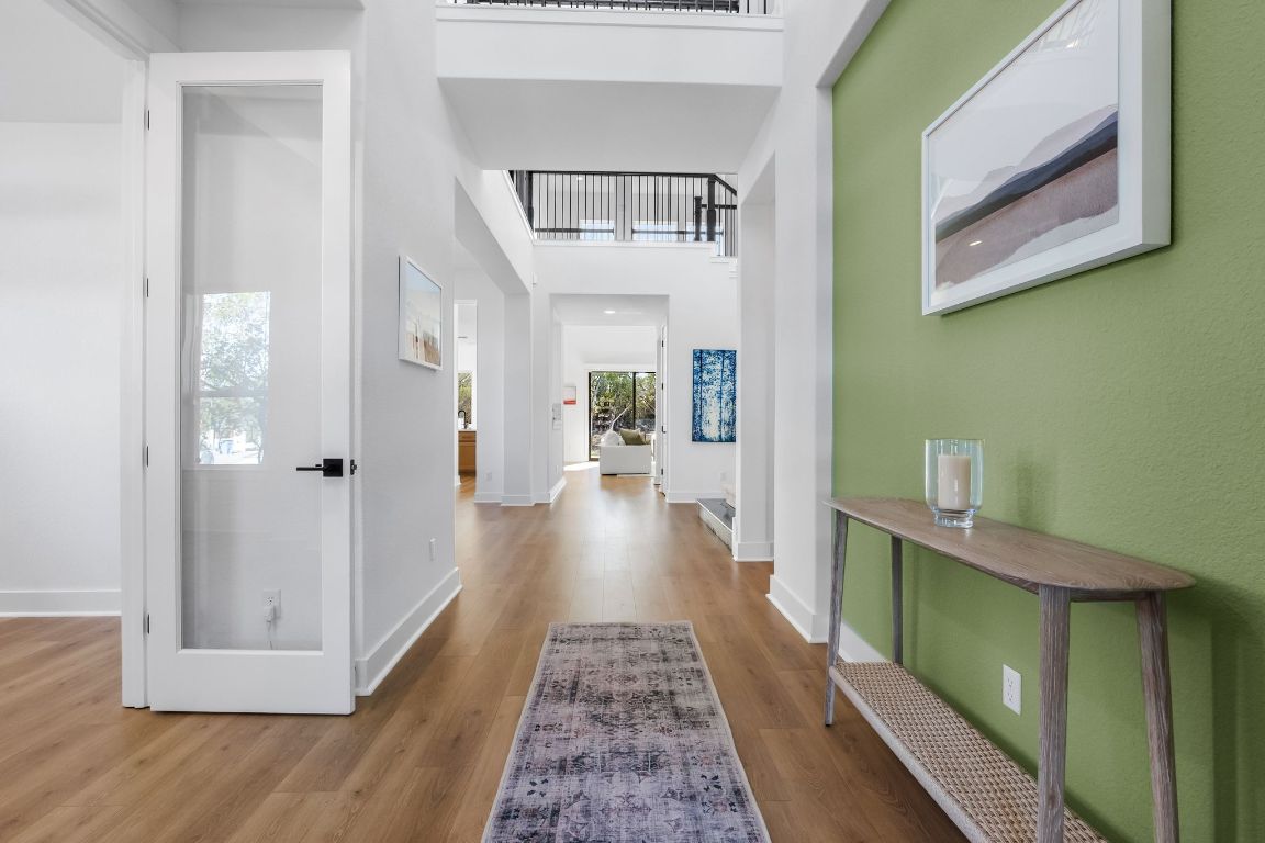 4612 Destination Way Jonestown, TX 78645 - Photo 25 of 37 a view of a hallway with wooden floor and staircase