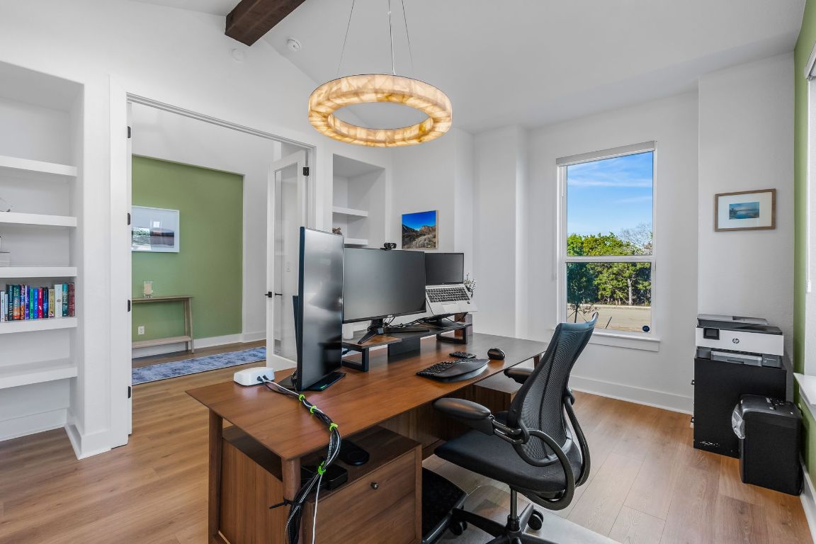 4612 Destination Way Jonestown, TX 78645 - Photo 27 of 37 a workspace with furniture and a chandelier