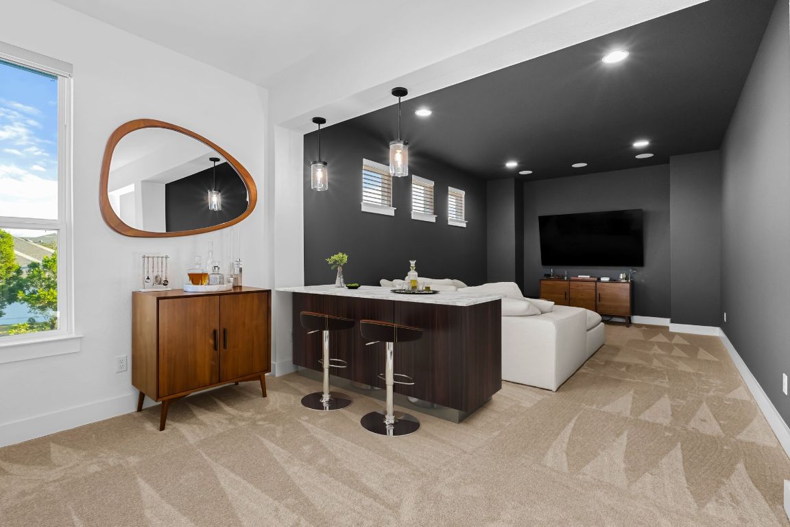 4612 Destination Way Jonestown, TX 78645 - Photo 29 of 37 a living room with furniture a flat screen tv and a sink
