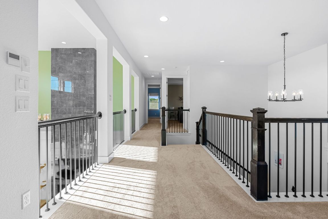 4612 Destination Way Jonestown, TX 78645 - Photo 30 of 37 a view of a hallway with wooden floor and windows