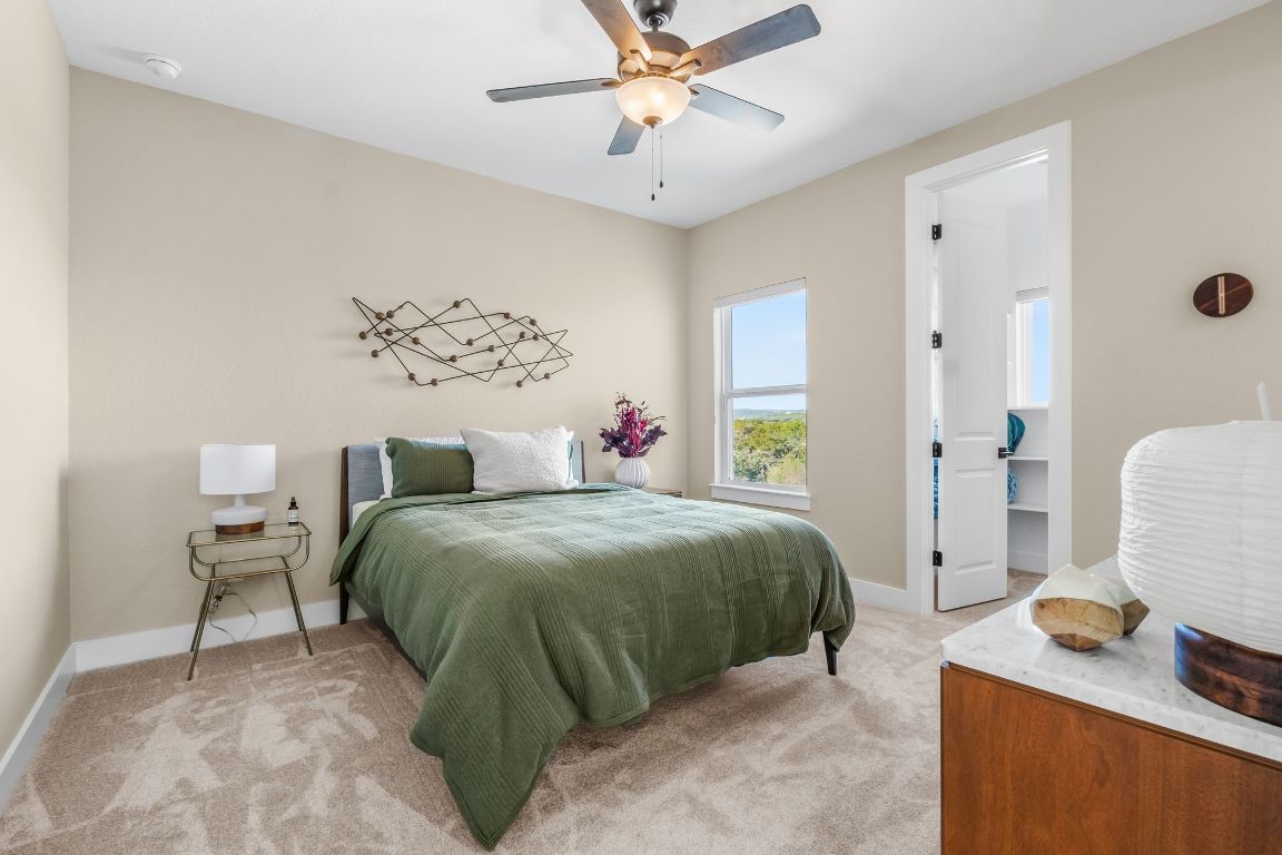 4612 Destination Way Jonestown, TX 78645 - Photo 31 of 37 a bedroom with a bed and a chandelier