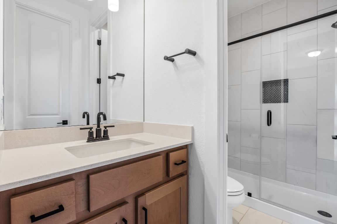 4612 Destination Way Jonestown, TX 78645 - Photo 34 of 37 a bathroom with a sink a toilet and shower