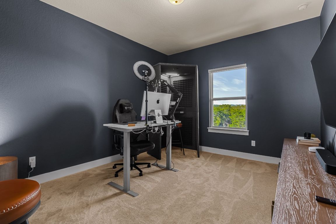 4612 Destination Way Jonestown, TX 78645 - Photo 35 of 37 a view of a workspace with furniture and a window