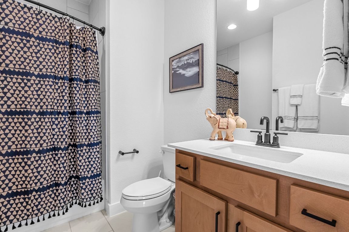 4612 Destination Way Jonestown, TX 78645 - Photo 36 of 37 a bathroom with a sink toilet vanity and shower
