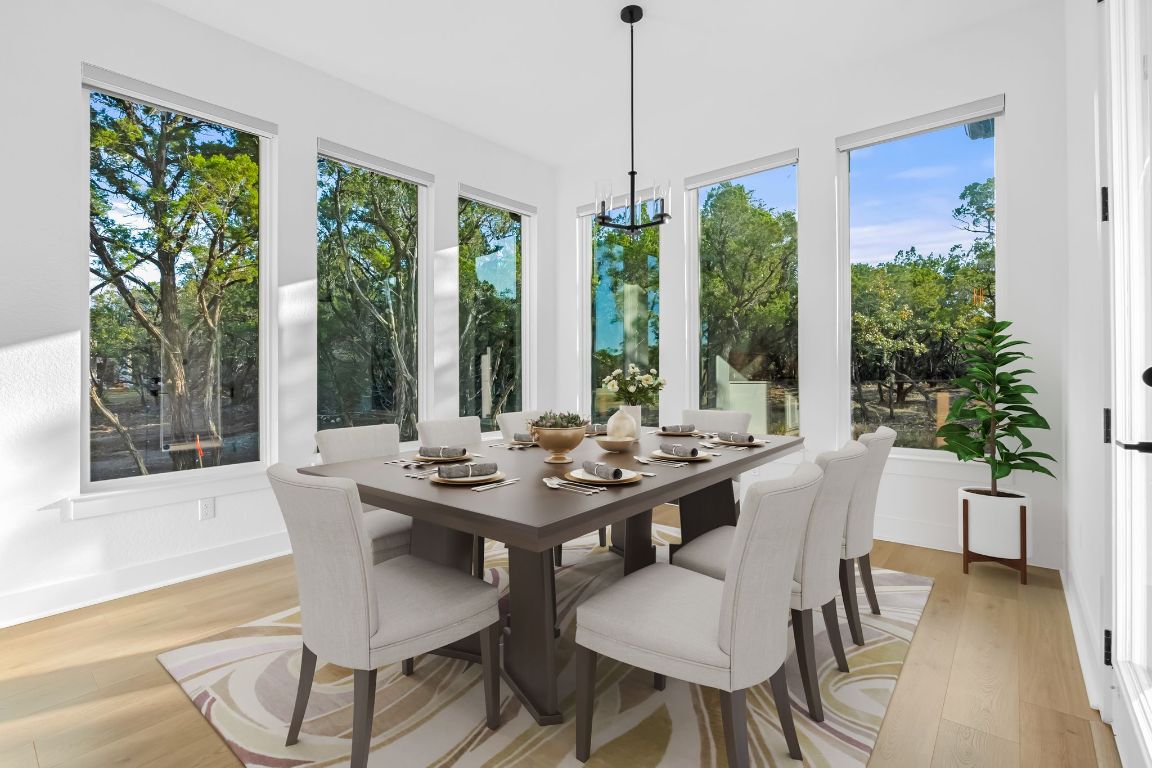 4612 Destination Way Jonestown, TX 78645 - Photo 7 of 37 a view of a dining room and livingroom with furniture wooden floor a chandelier
