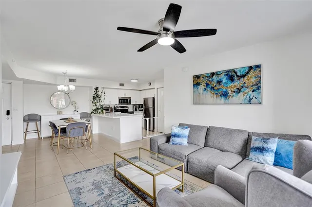 a living room with furniture and kitchen view