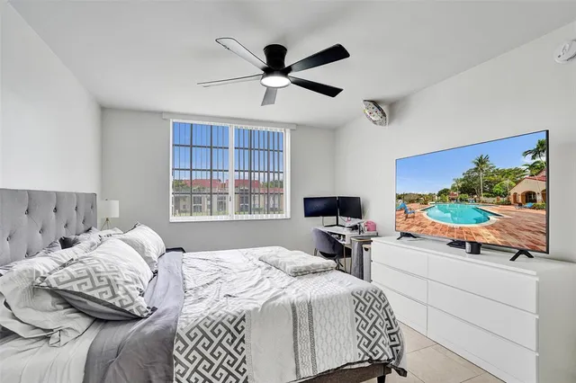 a bedroom with a bed and a large window