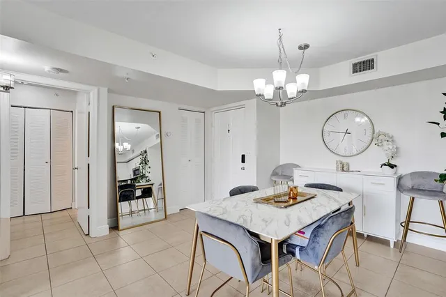 a view of a dining room with furniture and chandelier