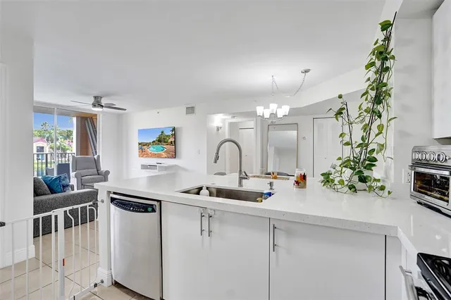 a kitchen with kitchen island a sink and a stove