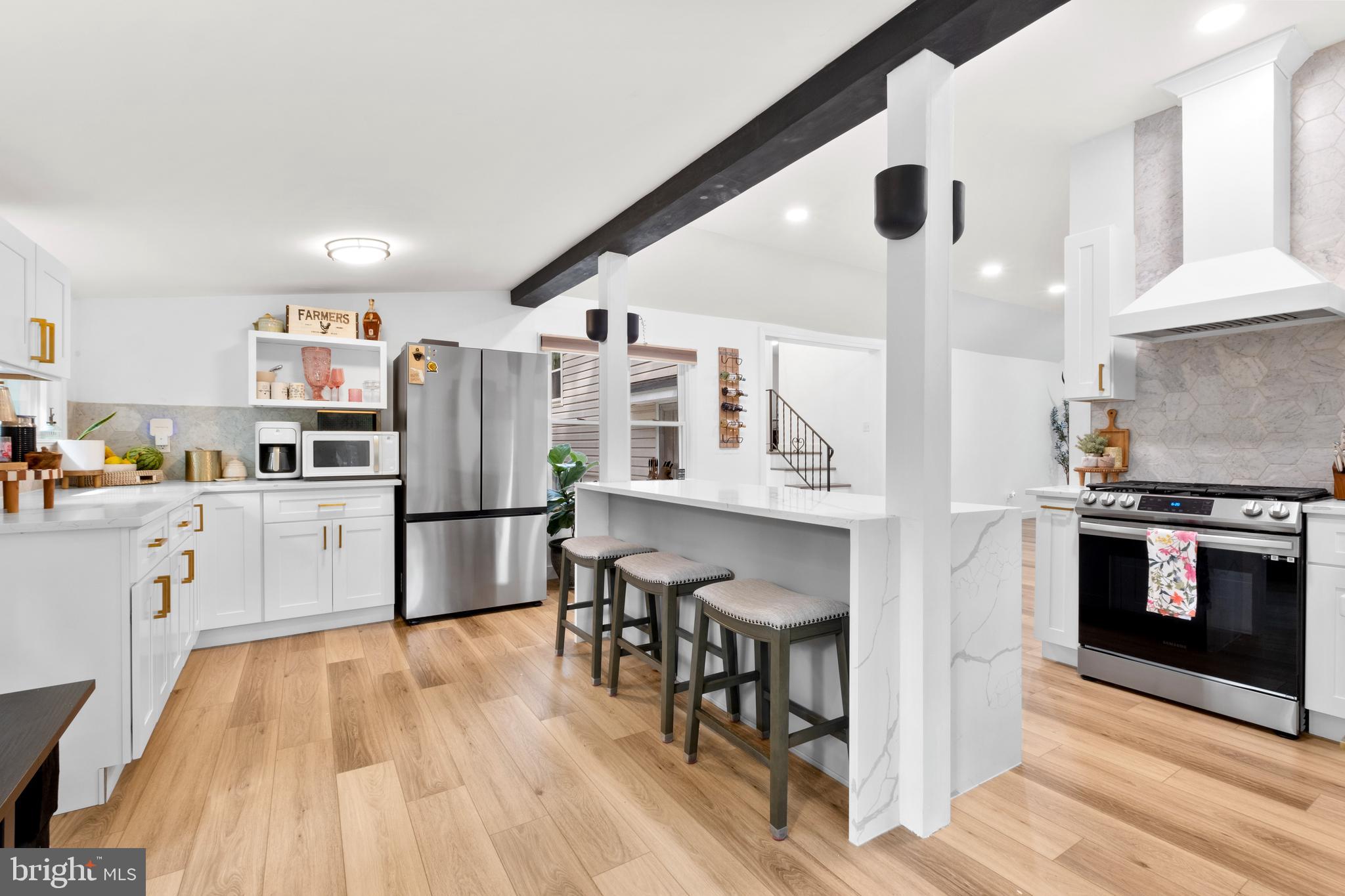 a kitchen with stainless steel appliances a stove a sink dishwasher and a refrigerator