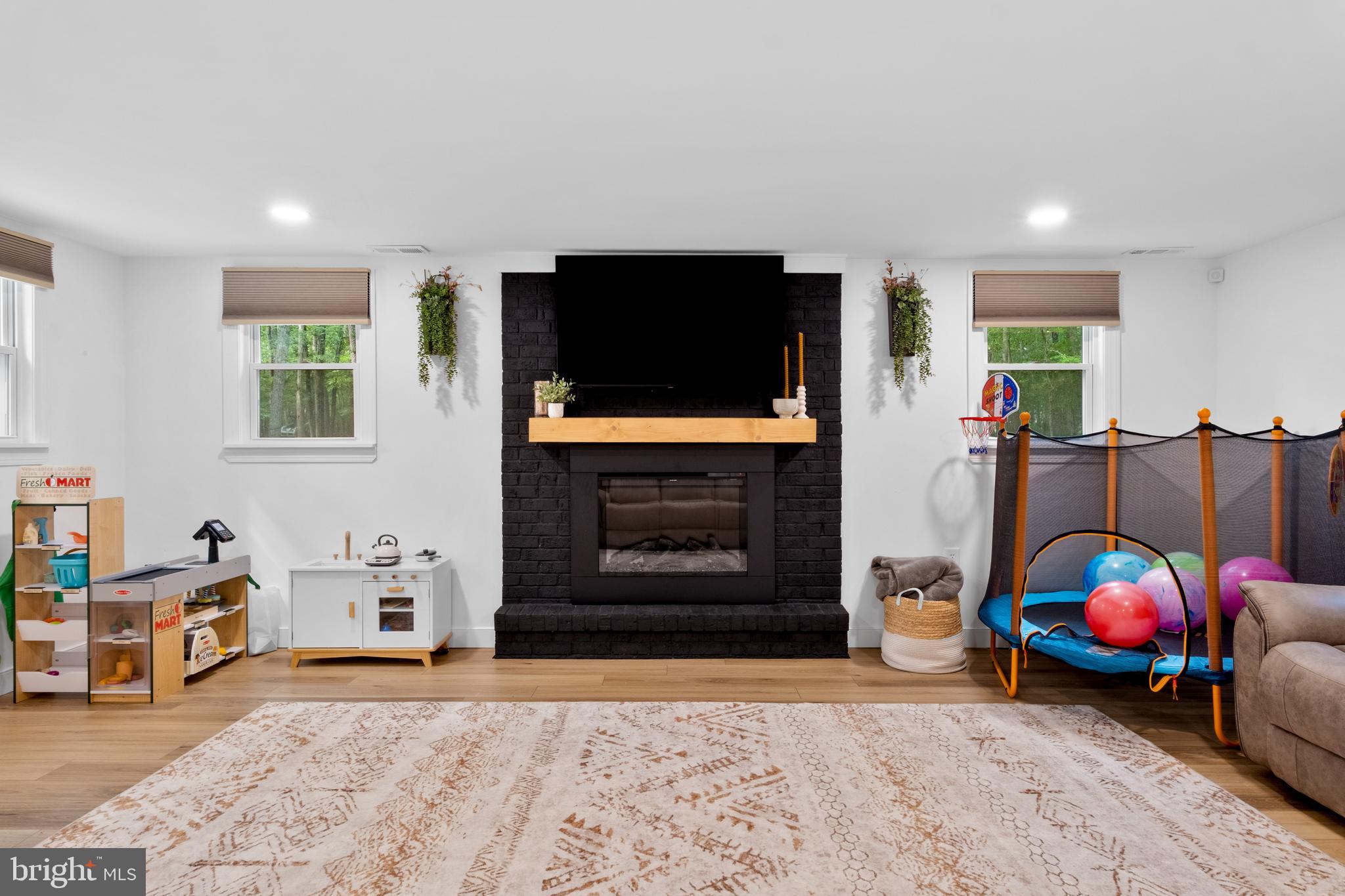 634 Tabernacle Road Medford, NJ 08055 - Photo 19 of 46 a living room with furniture a flat screen tv and a fireplace