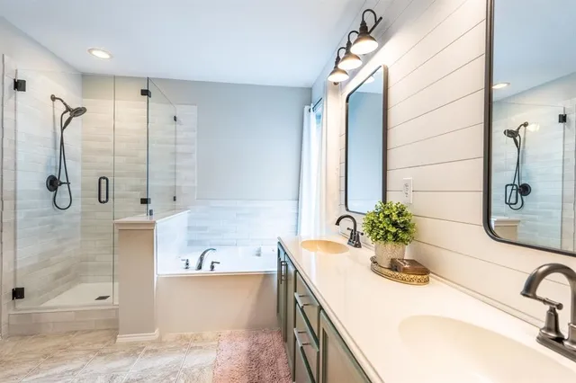 a bathroom with a tub sink and mirror