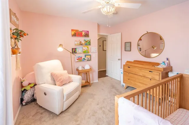 a living room with furniture and a mirror