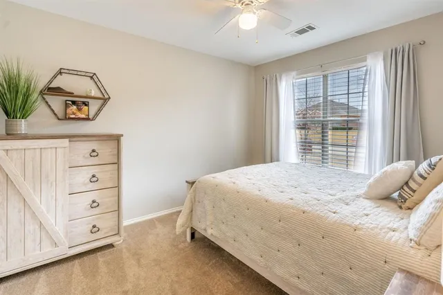 a bedroom with a bed and a dresser