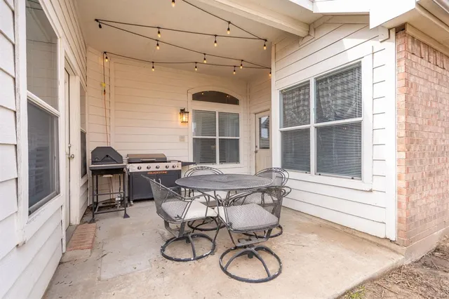 a balcony with table and chairs