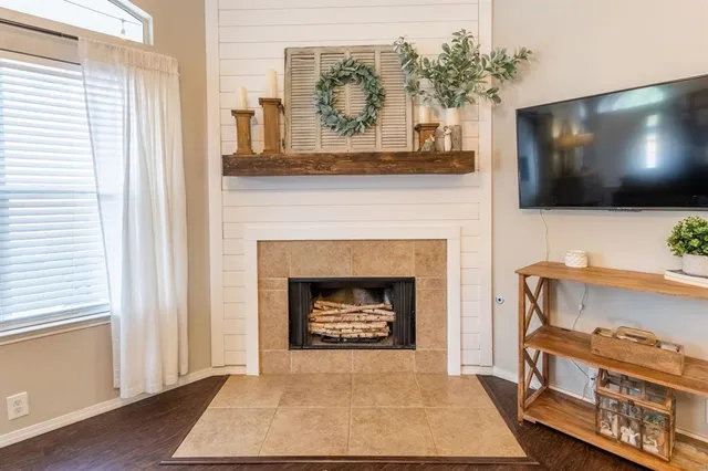 a living room with a fireplace and a flat screen tv