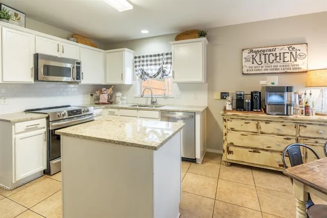 a kitchen with granite countertop a sink and cabinets