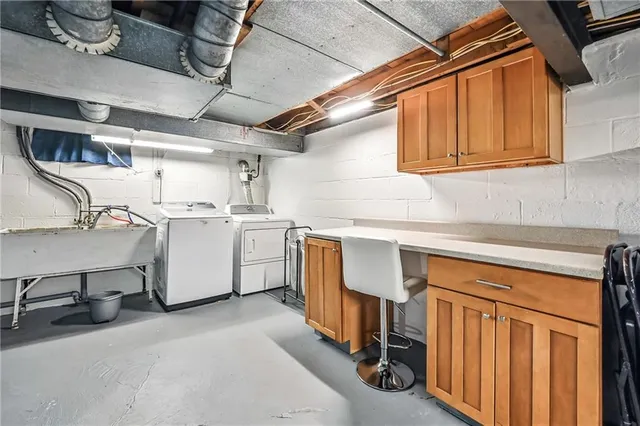 a utility room with sink dryer and washer