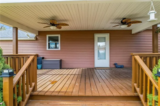 a view of backyard with wooden floor and fence