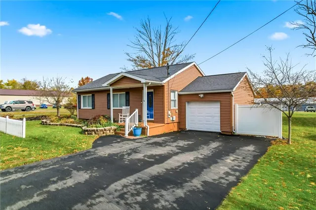 a front view of a house with garden