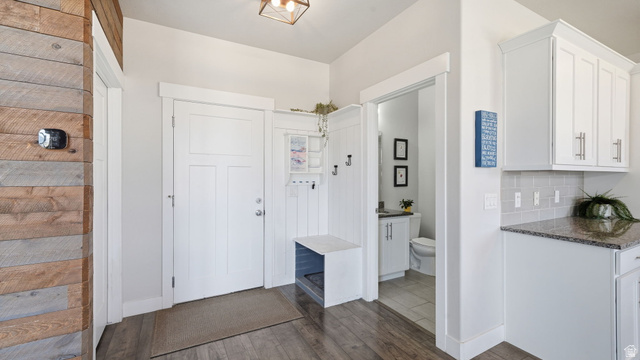 111 East Silver Oak Road Vineyard, UT 84059 - Photo 23 of 50 Entryway featuring wood-finish flooring, a white panel door, and a built-in mudroom bench with coat hooks