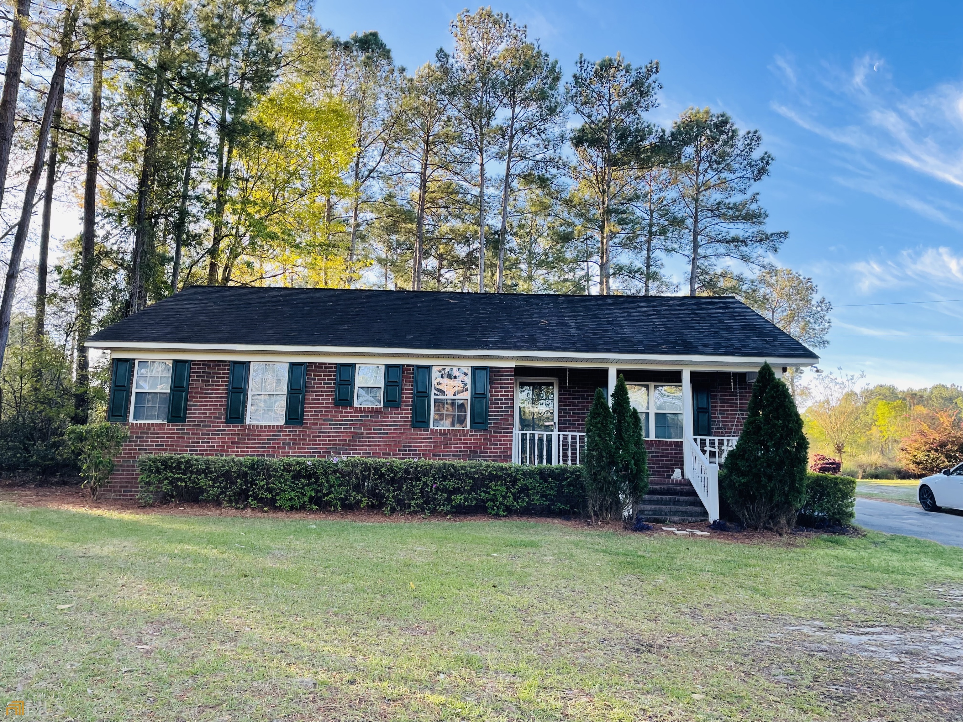 a view of a house with garden and yard