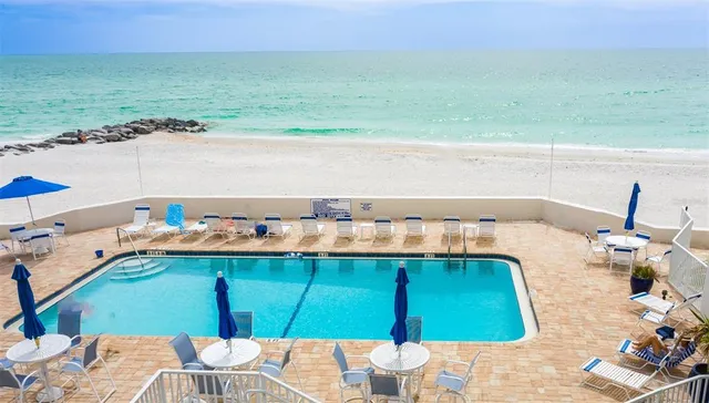 swimming pool view with a seating space