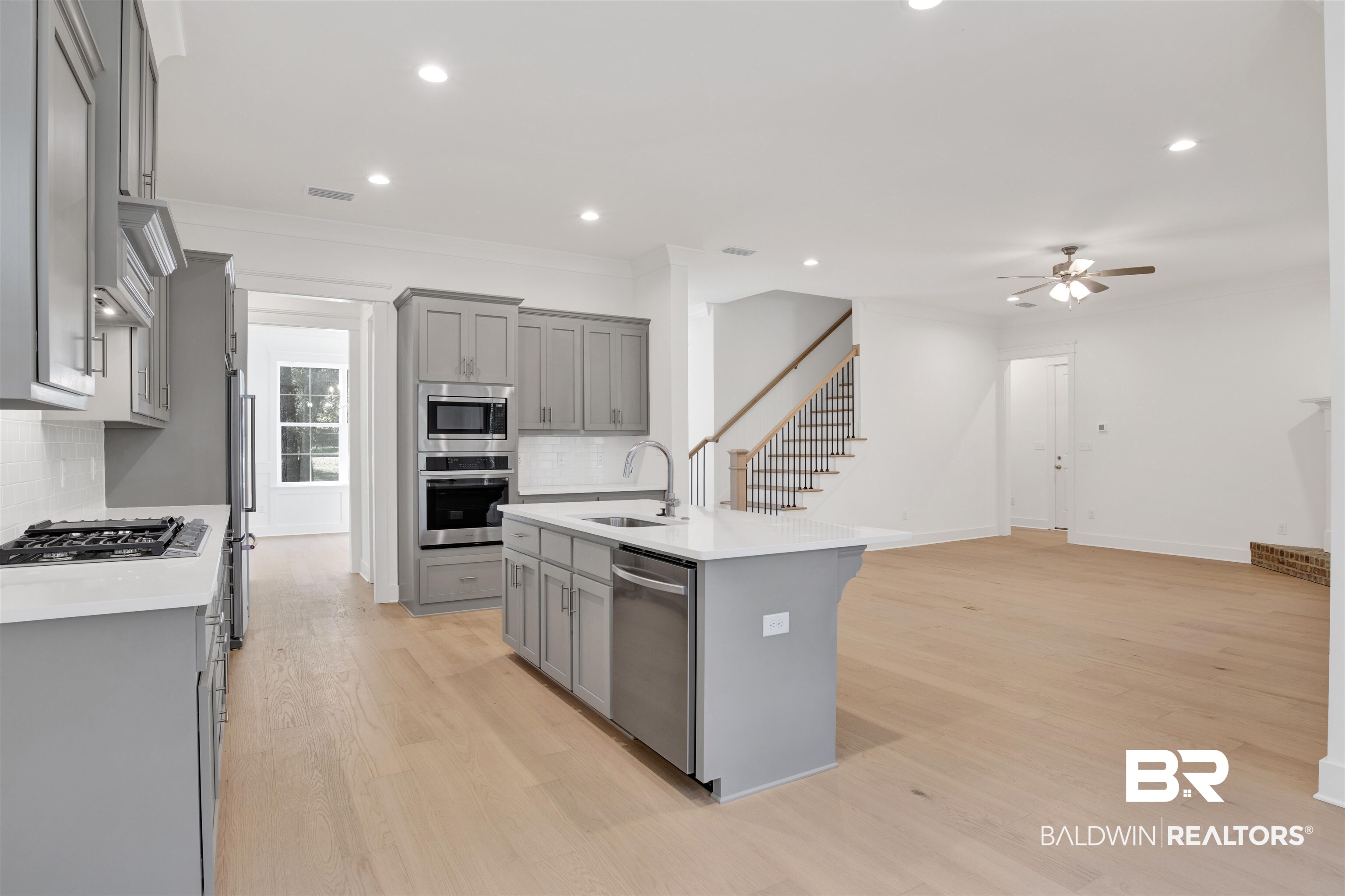 5 Long Leaf Circle Fairhope, AL 36532 - Photo 15 of 44 Kitchen featuring stainless steel appliances, gray cabinets, a center island with sink, and sink