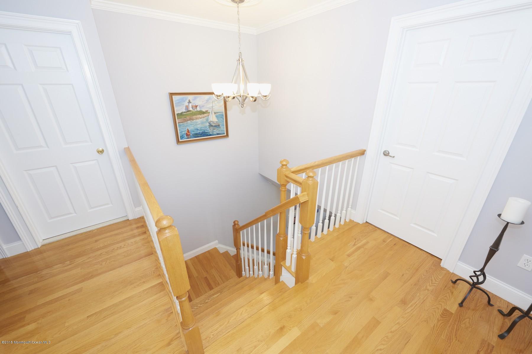 272 E Road Middletown, NJ 07718 - Photo 12 of 22 a view of a hallway with wooden floor and door